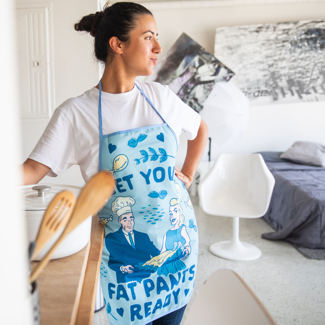 Women wearing apron that says Get your fat pants ready