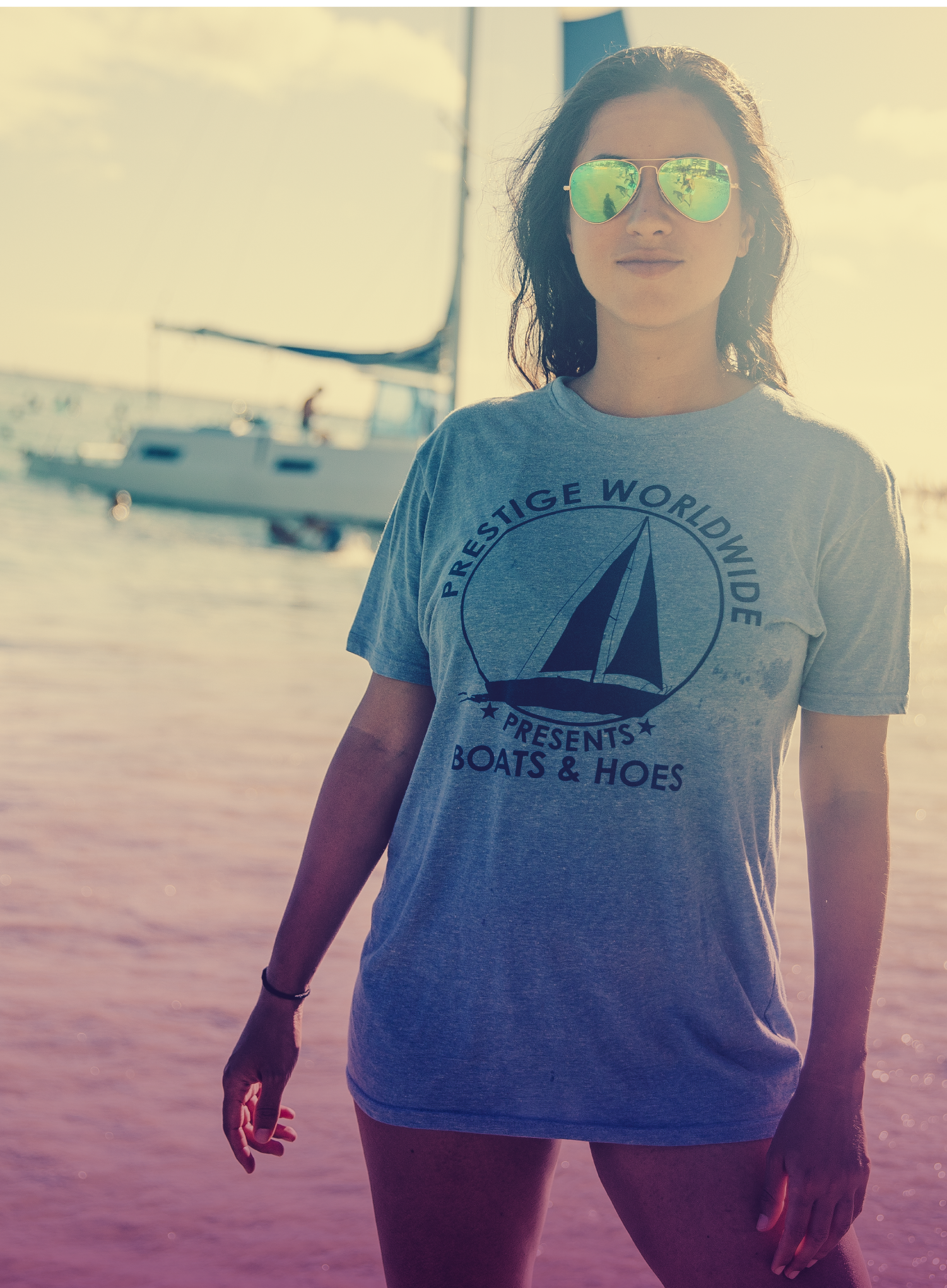 Woman with sunglasses wearing a prestige worldwide, boats & hoes, printed shirt